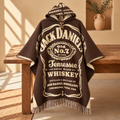 A brown hooded poncho with cream-colored Jack Daniel's Old No. 7 Tennessee Sour Mash Whiskey graphic print, draped over a rustic wooden bench in a warm, sunlit room.